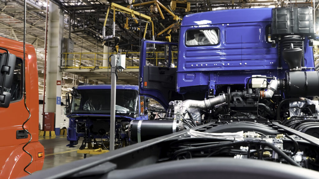 automobile assembly line production at the kamaz truck factory. scene. time lapse effect, industrial background with body frame hanging line, mechanical engineering concept.